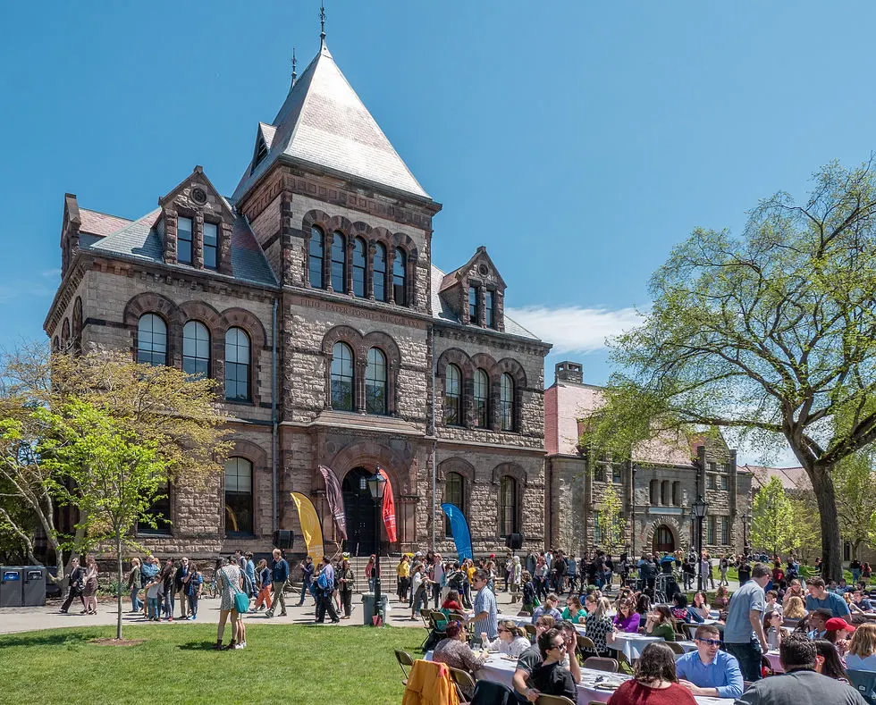 A large group of people in front of Sayles Hall